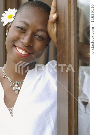 African American woman with flower behind her ear African American woman with flower behind her ear 11629110