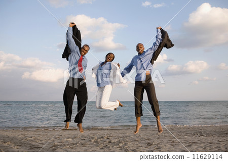 African businesspeople cheering at beach 11629114