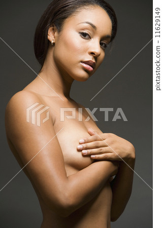Nude Hispanic woman with arms covering breasts Nude Hispanic woman with arms covering breasts 11629149
