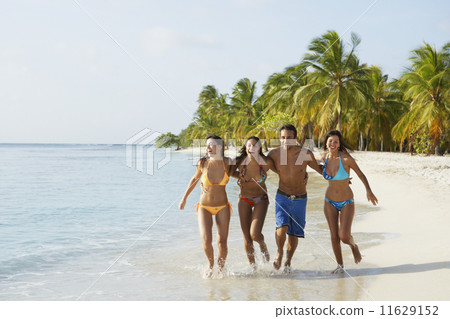 South American friends running at beach South American friends running at beach 11629152
