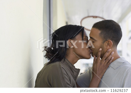 Multi-ethnic couple kissing Multi-ethnic couple kissing 11629237
