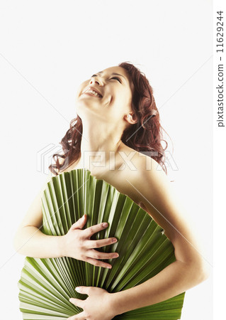 Nude Asian woman covered by large leaf 11629244