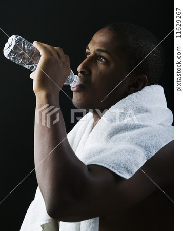 Young man drinking water after workout 11629267