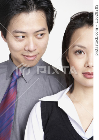 Close up of Asian businessman looking at Asian businesswoman Close up of Asian businessman looking at Asian businesswoman 11629285