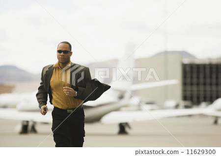 African man running from airplane 11629300