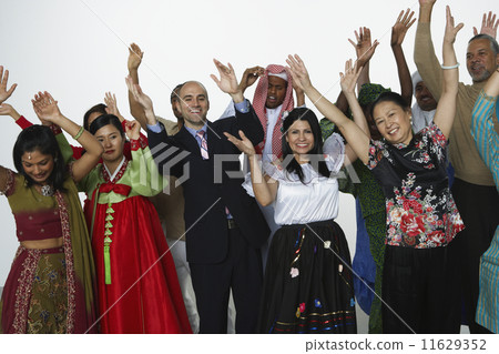Multi-ethnic people in traditional dress cheering Multi-ethnic people in traditional dress cheering 11629352