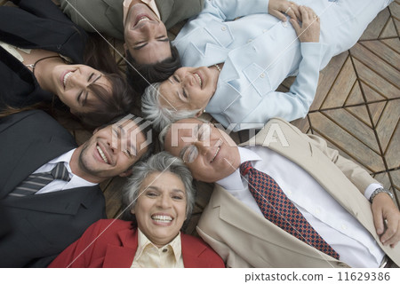 Hispanic businesspeople laying on floor Hispanic businesspeople laying on floor 11629386