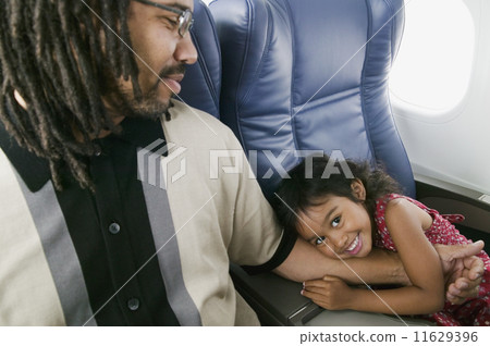 Portrait of young girl hugging father's arm 11629396