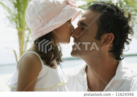 Hispanic girl kissing father on nose 11629398