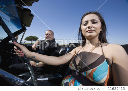 Hispanic couple in convertible Hispanic couple in convertible 11629413