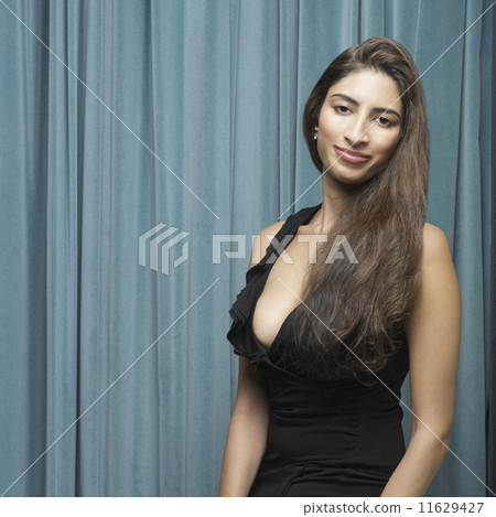 Portrait of Indian woman in front of curtain 11629427