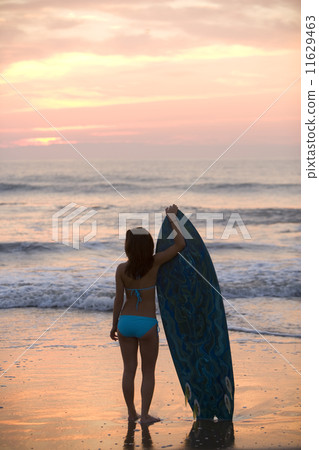 Asian girl holding surfboard at beach Asian girl holding surfboard at beach 11629463
