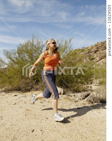 Senior Hispanic woman jogging Senior Hispanic woman jogging 11629505