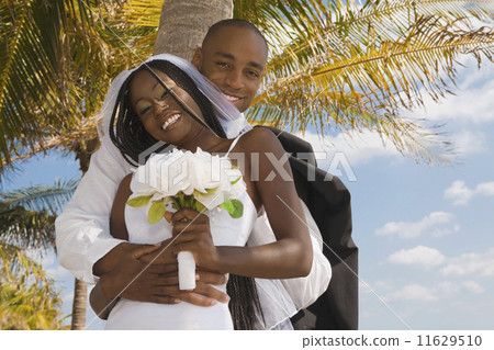 African bride and groom hugging 11629510