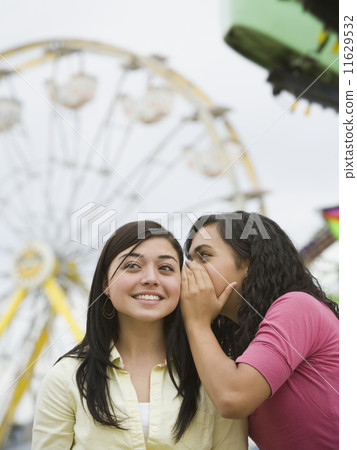 Multi-ethnic teenaged girls telling secret 11629532