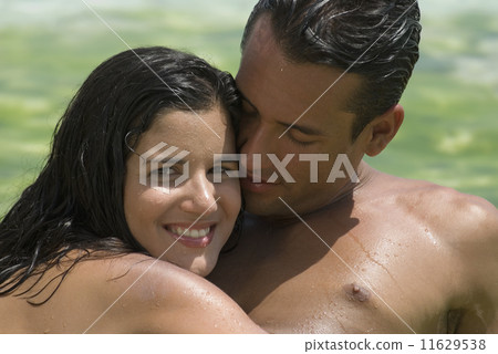 Hispanic couple hugging 11629538