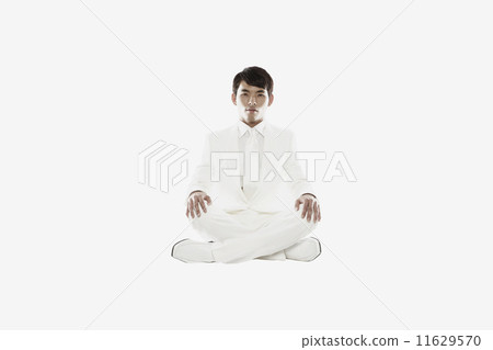 Asian businessman sitting cross-legged 11629570