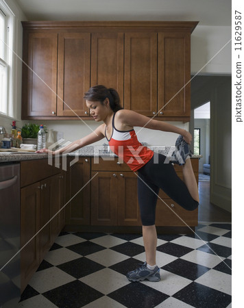 Pacific Islander woman stretching 11629587