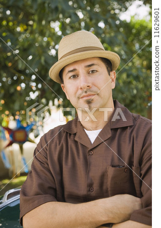 Hispanic man with arms crossed 11629601