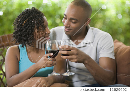 African couple toasting with wine African couple toasting with wine 11629602