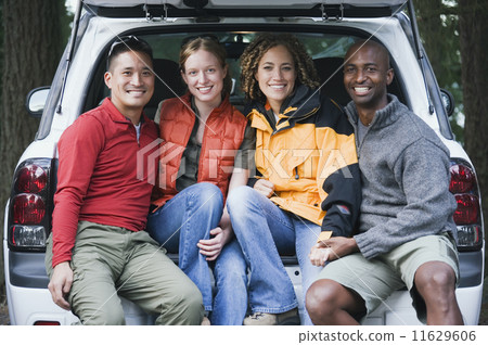 Friends sitting in the trunk of an SUV 11629606