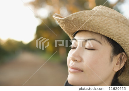Asian woman wearing cowboy hat Asian woman wearing cowboy hat 11629633