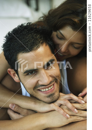 Hispanic couple hugging 11629658