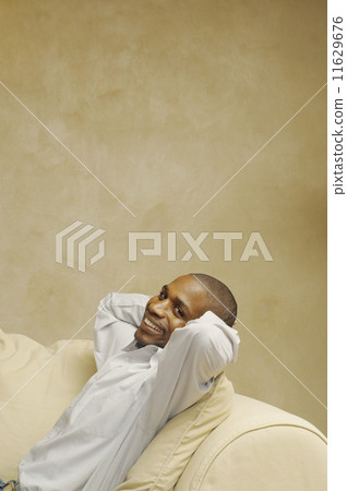 African American man sitting on sofa African American man sitting on sofa 11629676