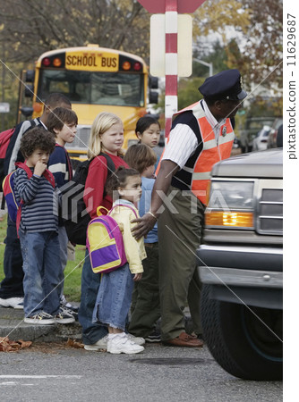 Children on street with crossing guard Children on street with crossing guard 11629687