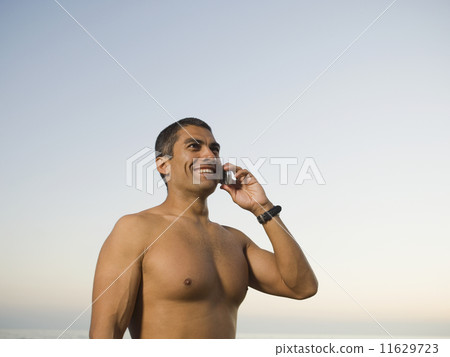 Hispanic man talking on cell phone 11629723
