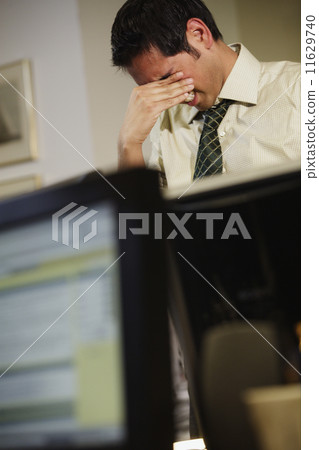 Businessman rubbing his eyes Businessman rubbing his eyes 11629740
