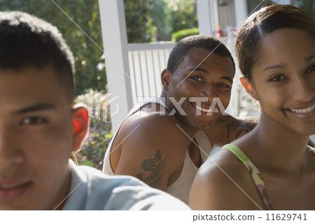 African man with friends on porch African man with friends on porch 11629741