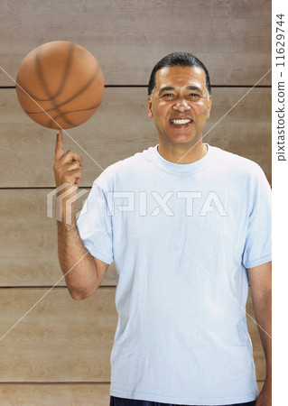 African man spinning basketball on finger 11629744