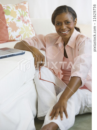 Senior African American woman next to laptop 11629756
