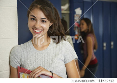 Teenaged girl in front of school lockers 11629758