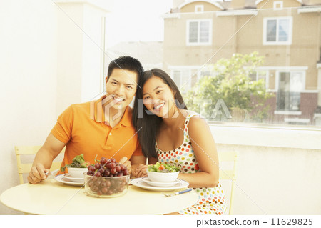 Asian couple at breakfast table 11629825