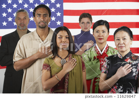 Multi-ethnic people standing in front of American flag Multi-ethnic people standing in front of American flag 11629847
