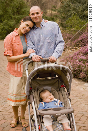 Hispanic parents with baby in stroller 11629919