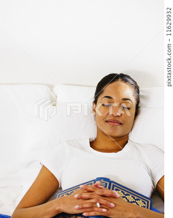 African woman sleeping with book 11629932