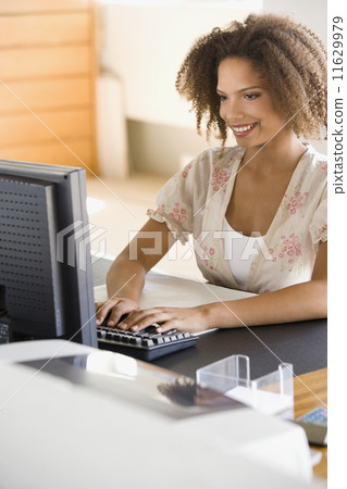 African businesswoman typing on computer 11629979