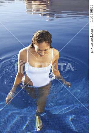 Woman walking in pool 11629992