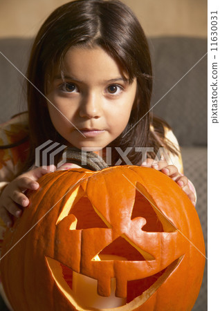 Young Hispanic girl with Jack-o-Lantern Young Hispanic girl with Jack-o-Lantern 11630031