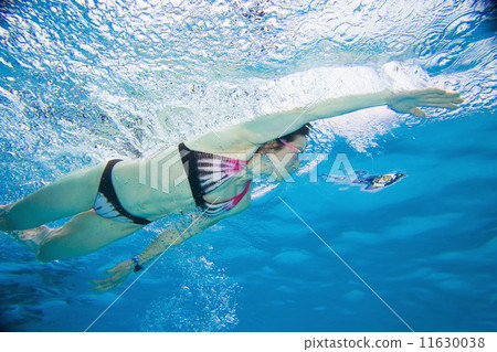 Underwater shot of Asian woman swimming Underwater shot of Asian woman swimming 11630038