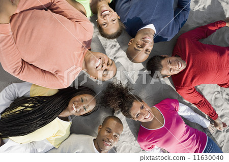 Multi-ethnic friends laying in circle Multi-ethnic friends laying in circle 11630040