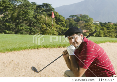 Hispanic man in golf course sand trap Hispanic man in golf course sand trap 11630057