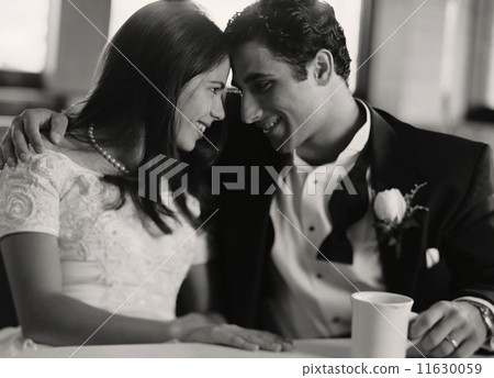 Bride and groom smiling at each other 11630059