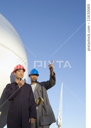 Multi-ethnic male construction workers pointing 11630069