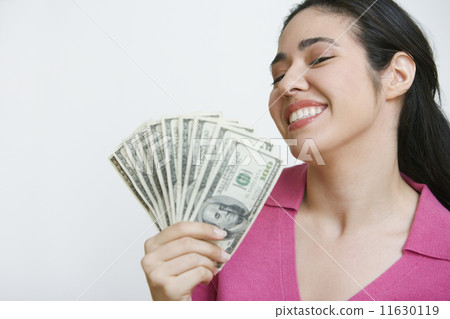 Woman holding out fan of money Woman holding out fan of money 11630119