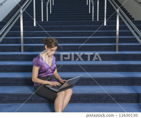Hispanic businesswoman typing on laptop Hispanic businesswoman typing on laptop 11630130