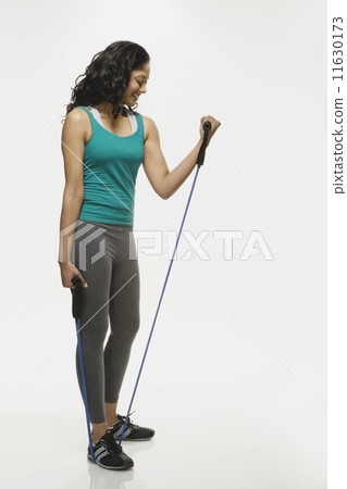 Indian woman using exercise band Indian woman using exercise band 11630173